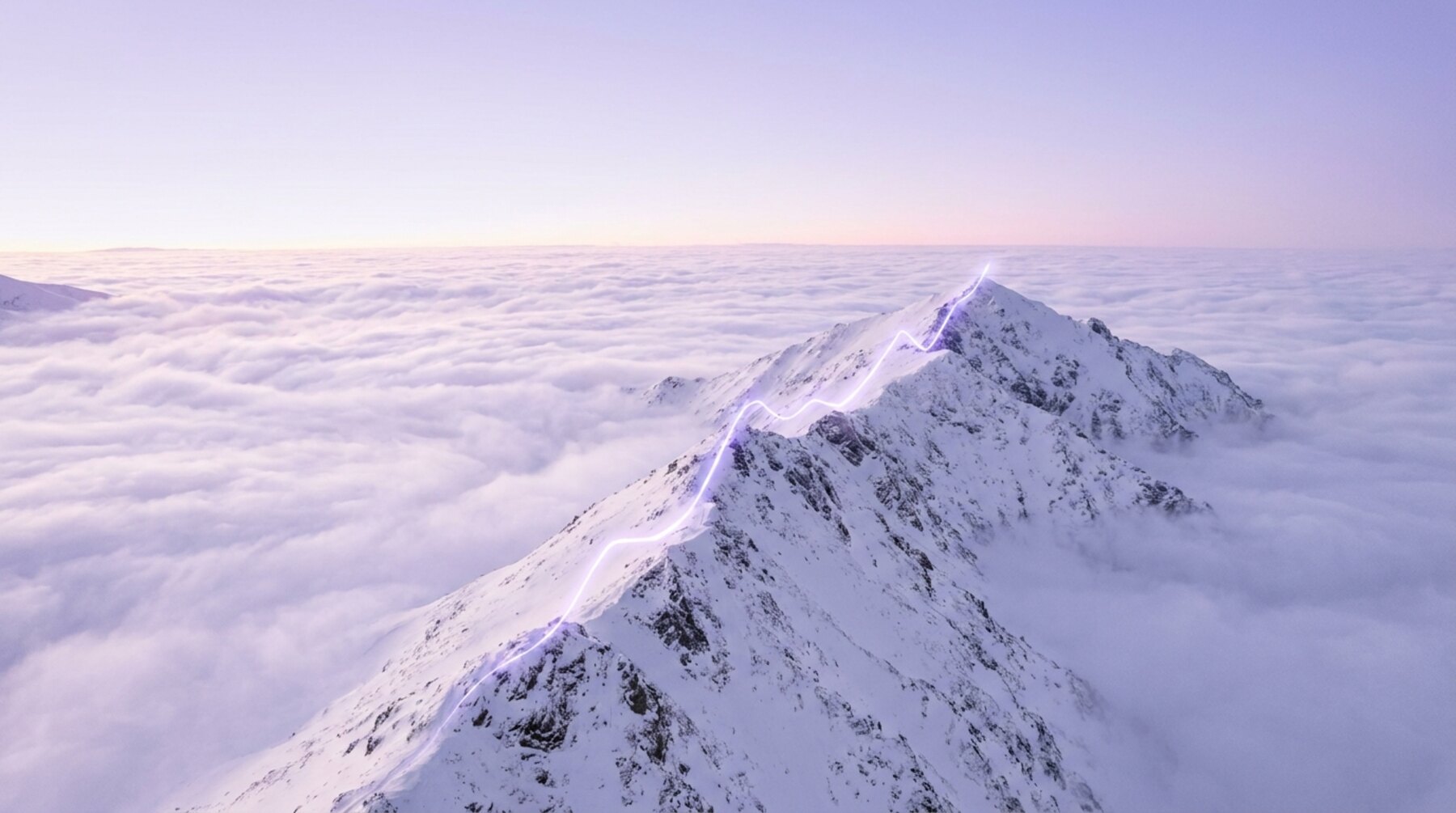 Snow ridge climbing above the clouds